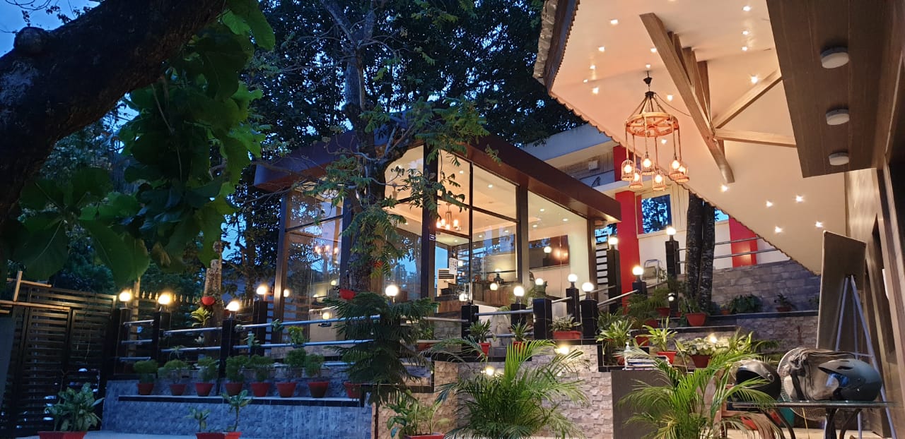 The open-air deck and cafeteria, lit by chandeliers and string lights