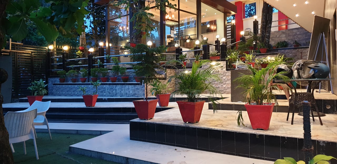 Tiered terrace with red planters leading up to the cafeteria